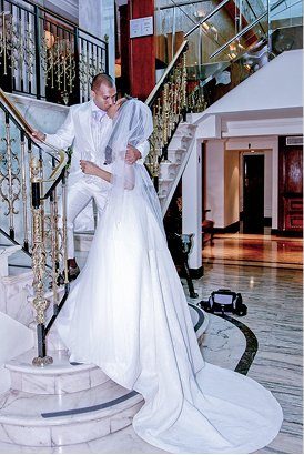 Bride and groom on a grand staircase