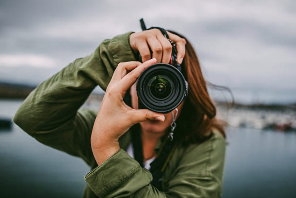 Photographer holding a camera up to her face